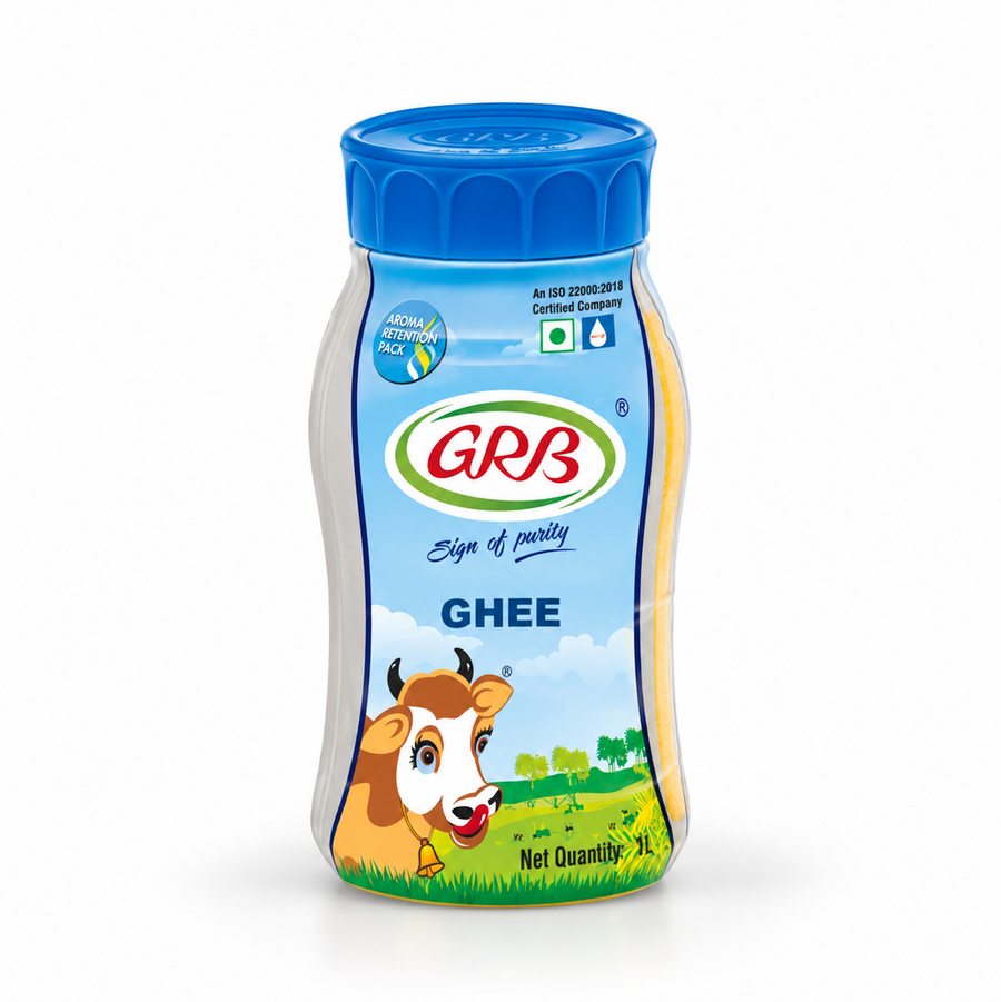 A 1 L white and blue jar of GRB Ghee featuring brand logos, a cow illustration, and an aroma-retention pack design, centered on a solid white background. Available in the UK at theindianshelf.co.uk.
