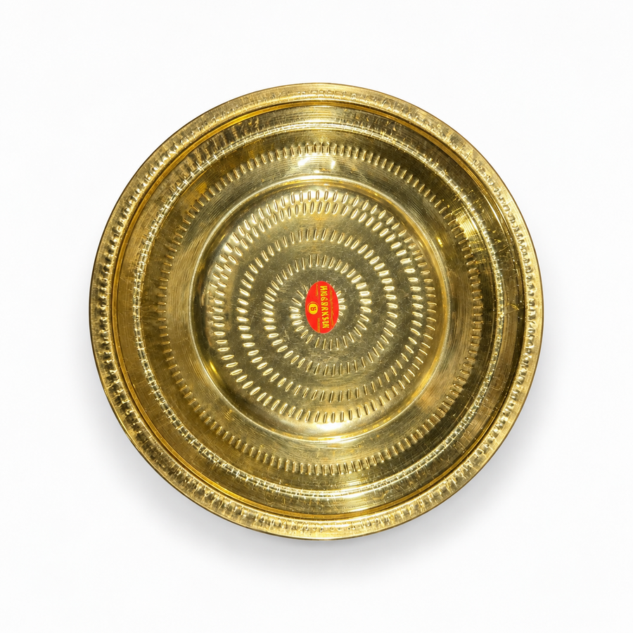 A 13-inch brass thambulam plate featuring a detailed dot-press textured pattern and a polished golden finish, centered on a solid white background. Available in the UK at theindianshelf.co.uk.