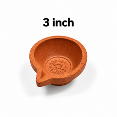 A 3-inch single-face terracotta mud lamp (agal vilakku) featuring a small embossed flower motif at the base, centered on a solid white background with a "2 inch" label above it. Available in the UK at theindianshelf.co.uk.