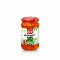 This image displays a glass jar of Ajmi Kadumango Pickle (Raw Mango Pickle), which has a red lid and a label indicating a Net Wt. 400g. The label features the Ajmi brand name and a picture of small, diced green mango pieces. The pickle itself is a rich, reddish-orange color, visible through the jar. This traditional Indian condiment is sold internationally and is available through various retailers, including those like The Indian Shelf UK.