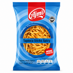 A professional studio shot of the Ajmi Tapioca Sticks Spicy packaging as seen in image_d4bcd7.jpg. The bag features a vibrant blue design with concentric circular patterns. A central circular window reveals the thin, golden-orange spicy tapioca sticks inside. The red "Ajmi" logo is centered at the top, and a red "MORE CRUNCHY" seal is featured on the lower right. This product is available in the UK at theindianshelf.co.uk.