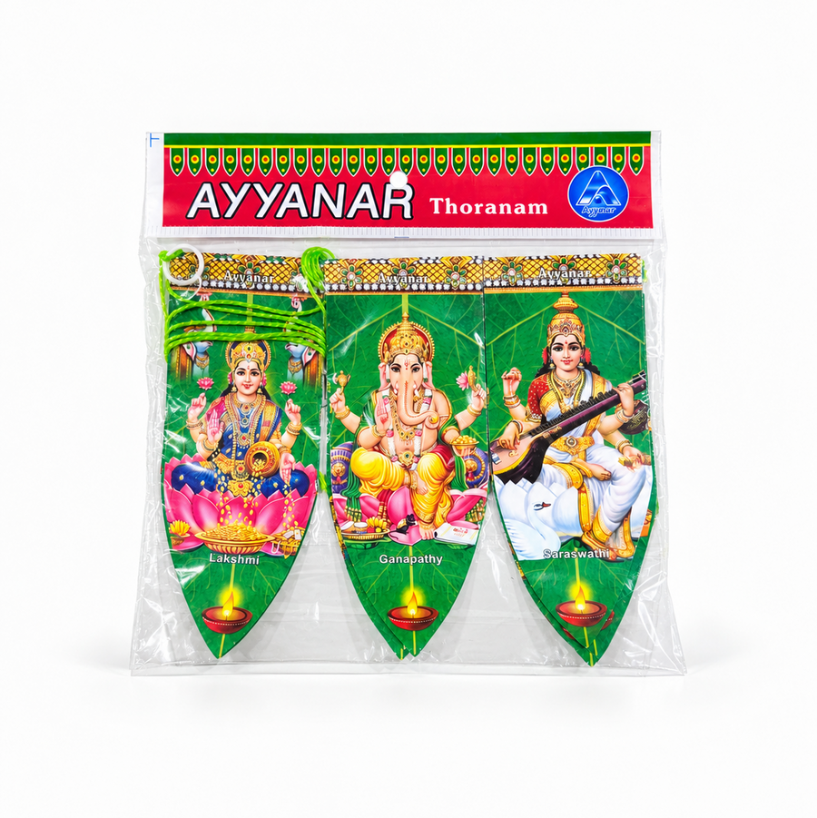 A packaged Ayyanar Mango Leaf Thoranam door hanging featuring illustrated panels of deities Lakshmi, Ganapathy, and Saraswathi, centered on a solid white background. Available in the UK at theindianshelf.co.uk.