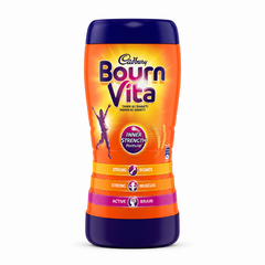 A professional studio shot of a tall, hourglass-shaped Cadbury Bournvita plastic jar standing vertically on solid white background. The container features a vibrant orange body framed by dark purple caps at both the top and bottom. The upper section features a sunburst graphic behind the prominent purple and yellow "Cadbury Bournvita" logo, alongside a silhouette of a celebrating child and a circular badge reading "INNER STRENGTH Formula". This product is available in the UK at theindianshelf.co.uk.