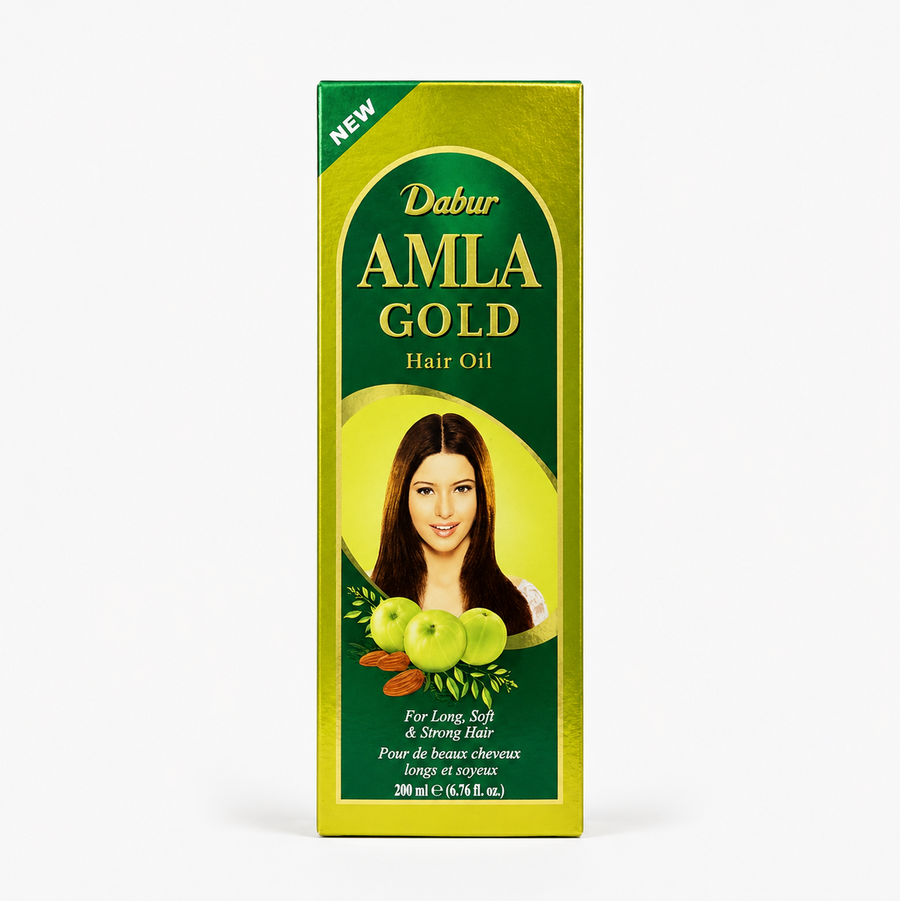 A professional studio shot of the vertically oriented, rectangular cardboard packaging for Dabur Amla Gold Hair Oil . The box features a metallic golden-green border with a distinct dark green arched central panel. At the top left corner, a bright green triangular banner reads "NEW" in bold white text. Inside the dark green arch, the brand name "Dabur" is printed in a gold script, followed by "AMLA" and "GOLD" in large, This product is available in the UK at theindianshelf.co.uk.