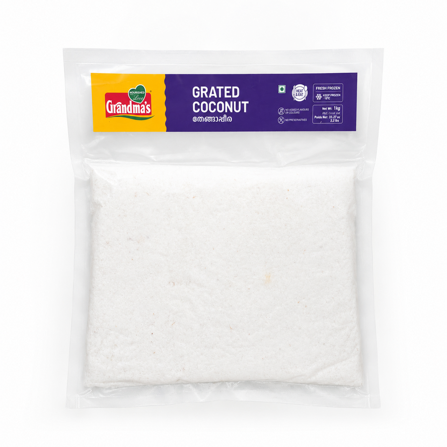 A professional studio product shot of a 1kg flat vacuum-sealed transparent pouch of Grandma's Fresh Frozen Grated Coconut isolated against a pure white background. The clear packaging showcases a solid square block of snowy white grated coconut below a prominent yellow and purple top header label displaying the brand logo, product name, and certifications. This product is available in the UK at theindianshelf.co.uk.