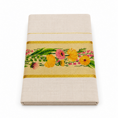A studio product shot of a neatly folded Kerala Floral Set Saree on a plain white background. The off-white fabric displays a broad golden border intricately embroidered with vivid yellow and pink flowers with green leaves. Available in the UK at theindianshelf.co.uk.