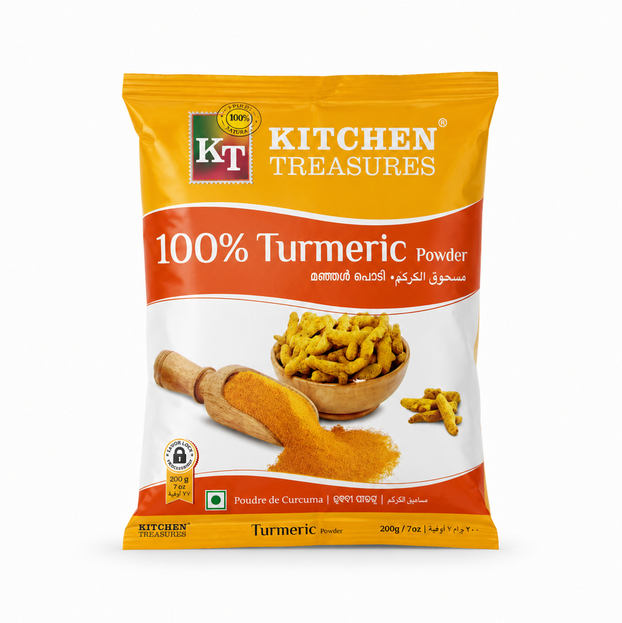 A professional studio product shot of a 200g retail pillow pouch of Kitchen Treasures 100% Turmeric Powder isolated against a pure white background in image_c093f3.jpg. The packaging features a vibrant yellow, white, and orange design showcasing the brand logo alongside a graphic illustration of fresh turmeric bulbs in a wooden bowl next to a wooden scoop spilling finely ground golden turmeric powder. This product is available in the UK at theindianshelf.co.uk.