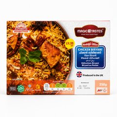 A professional studio shot of a landscape-oriented rectangular cardboard box for Magic Tastes Chicken Biryani (Nostalgic Edition) The left half of the packaging displays a rich, appetizing close-up graphic of a copper handi filled with golden-hued basmati rice, caramelized onions, fresh green herbs, a star anise pod, and a succulent piece of roasted chicken. Small square logos in the lower-left corner read "READY TO EAT," "HALAL," This product is available in the UK at theindianshelf.co.uk.