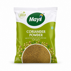 A professional studio shot of the Mayil Coriander Powder packaging. The bag features a clean white top section with a green "Mayil" logo and a small leaf icon with the text "A TOUCH OF PARADISE IN EVERY SPICESThis product is available in the UK at theindianshelf.co.uk.