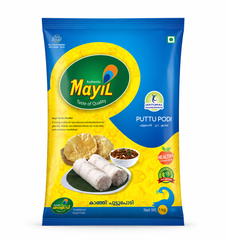 A high-quality studio shot of a 1kg packet of Mayil Puttu Podi. The packaging features a vibrant blue and yellow design with a large green oval containing the "Mayil" peacock logo. accompanied by a small white bowl of curry and golden papadums. Several quality seals, including "Natural Ingredients," "Healthy Steam Food," and "100% Natural," are clearly visible. The net weight is marked as 1 kg . this product is available in the UK at theindianshelf.co.uk.