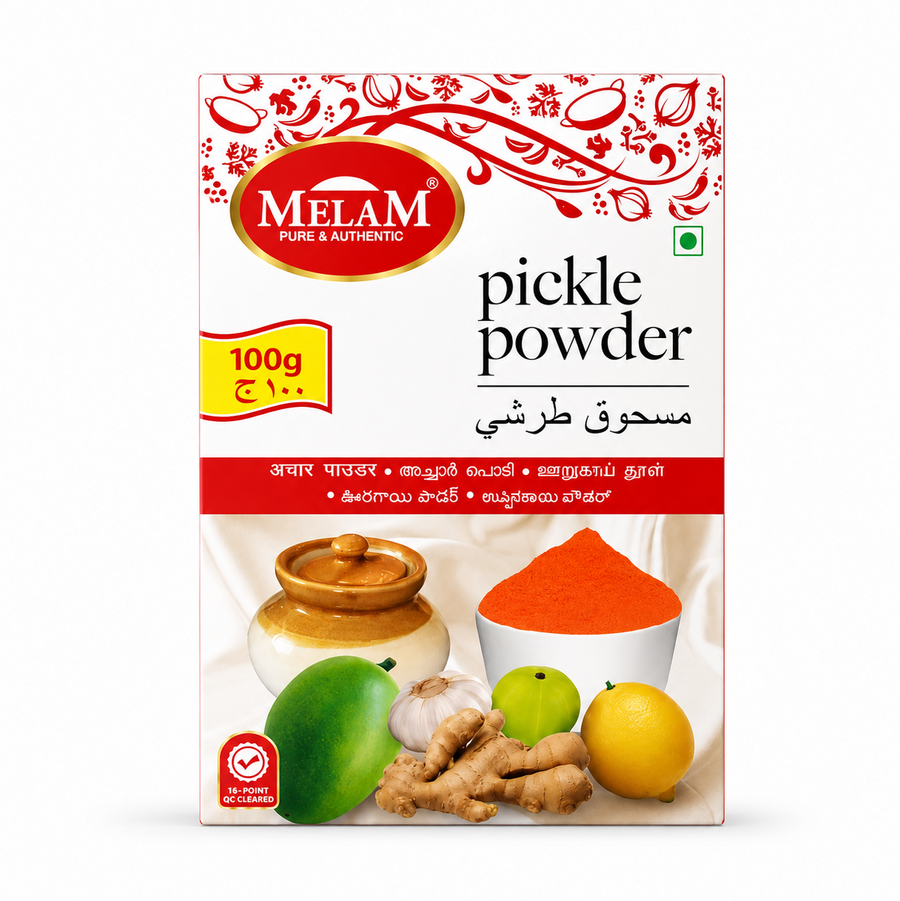 Studio product shot of a rectangular box of Melam Pickle Powder against a white background. The top features a red patterned design with the oval gold-and-red "MELAM" logo. The title "pickle powder" is printed boldly on the right. A central graphic shows a traditional ceramic pickle jar next to a white bowl of red spice powder, surrounded by a raw mango, garlic, ginger, gooseberry, and lemon. A yellow badge highlights "100g". Available in the UK at theindianshelf.co.uk.