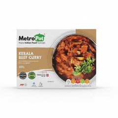 A white and tan box of Metro Pot Kerala Beef Curry (300g). The packaging features a large bowl of rich, dark beef curry garnished with fresh coriander. The label describes it as "Best cooked in thick gravy with herbs and spices" and prominently displays the "Produced in the UK" logo along with Quality and Authentic Handmade Indian Food seals.
This authentic Kerala-style dish is available for purchase in the UK at theindianshelf.co.uk.