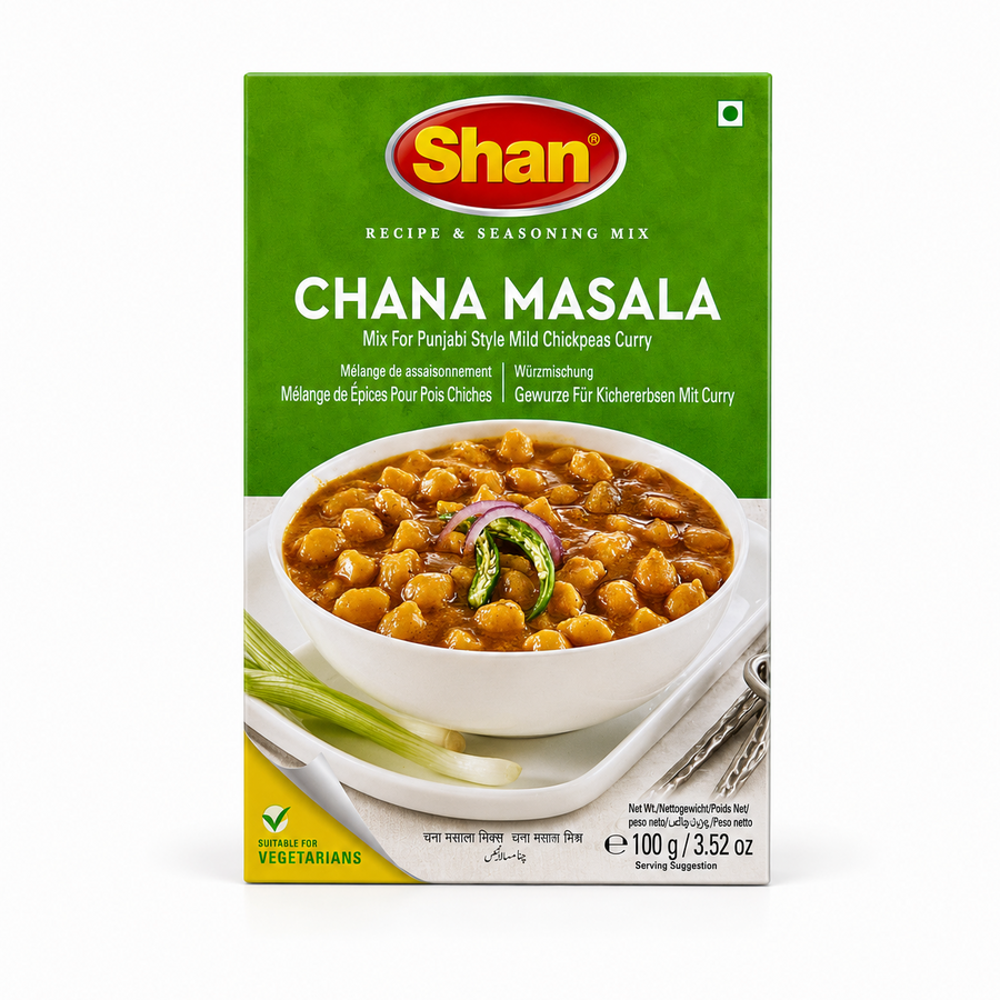 A 100g box of Shan Chana Masala Recipe & Seasoning Mix centered on a solid white background, featuring a bright green top section with the Shan logo and a serving suggestion showing a white bowl filled with chickpeas in gravy garnished with sliced onion rings and green chilies. This product is available in the UK at theindianshelf.co.uk.