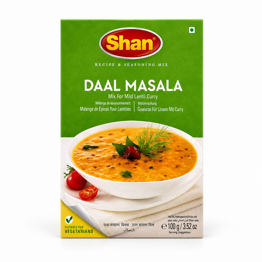 A 100g box of Shan Daal Masala Recipe & Seasoning Mix centered on a solid white background, featuring a vibrant green top section with the Shan logo and a serving suggestion showing a white bowl filled with golden lentil curry tempered with cumin, chili, and fresh herbs. This product is available in the UK at theindianshelf.co.uk.