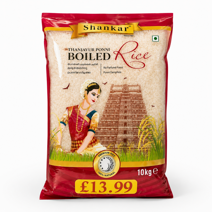 A professional studio shot of a 10 kg bag of Shankar Thanjavur Ponni Boiled Rice. The packaging features a deep red border with a clear central window that showcases the cream-colored rice grains inside. The brand name "Shankar" is prominently displayed in black on a golden ribbon at the top. The central artwork illustrates a woman in traditional South Indian attire sitting near a large temple gopuram and golden stalks of rice.This product is available in the UK at theindianshelf.co.uk.