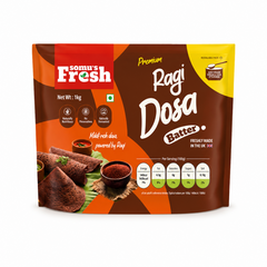 A studio product shot of a 1kg resealable stand-up pouch of Somu's Fresh Premium Ragi Dosa Batter isolated against a white background. The brown and orange packaging displays cooked ragi dosas on a banana leaf alongside a nutritional breakdown.