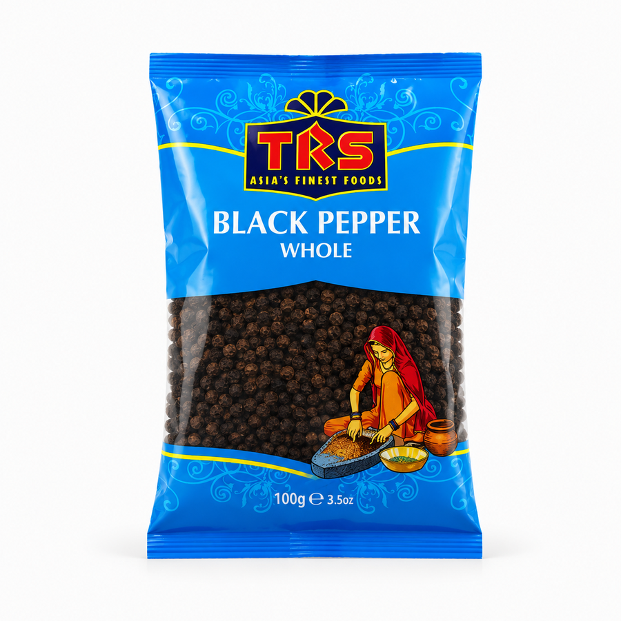 A 100g pouch of TRS Black Pepper Whole centered on a solid white background, featuring a vibrant blue packaging design with the TRS logo and a clear window showing whole black peppercorns next to an illustration of a traditional Indian woman using a grinding stone. This product is available in the UK at theindianshelf.co.uk.