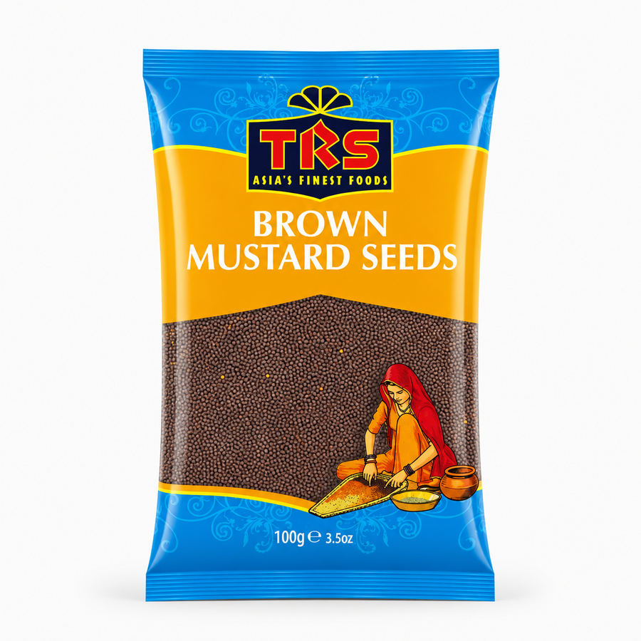 A 100g pouch of TRS Brown Mustard Seeds centered on a solid white background, featuring a vibrant yellow and blue packaging design with the TRS logo and a clear window showing small brown mustard seeds next to an illustration of a traditional Indian woman. This product is available in the UK at theindianshelf.co.uk.