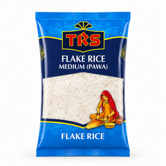 A pouch of TRS Flake Rice Medium (Pawa) centered on a solid white background, featuring a blue and dark navy packaging design with the TRS logo and a clear window displaying white flattened rice flakes next to an illustration of a traditional Indian woman. This product is available in the UK at theindianshelf.co.uk.