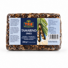 A 200g block of compressed TRS Tamarind (Imli) centered on a solid white background, featuring a blue label with the TRS logo and an illustration of tamarind pods hanging from a branch. This product is available in the UK at theindianshelf.co.uk.