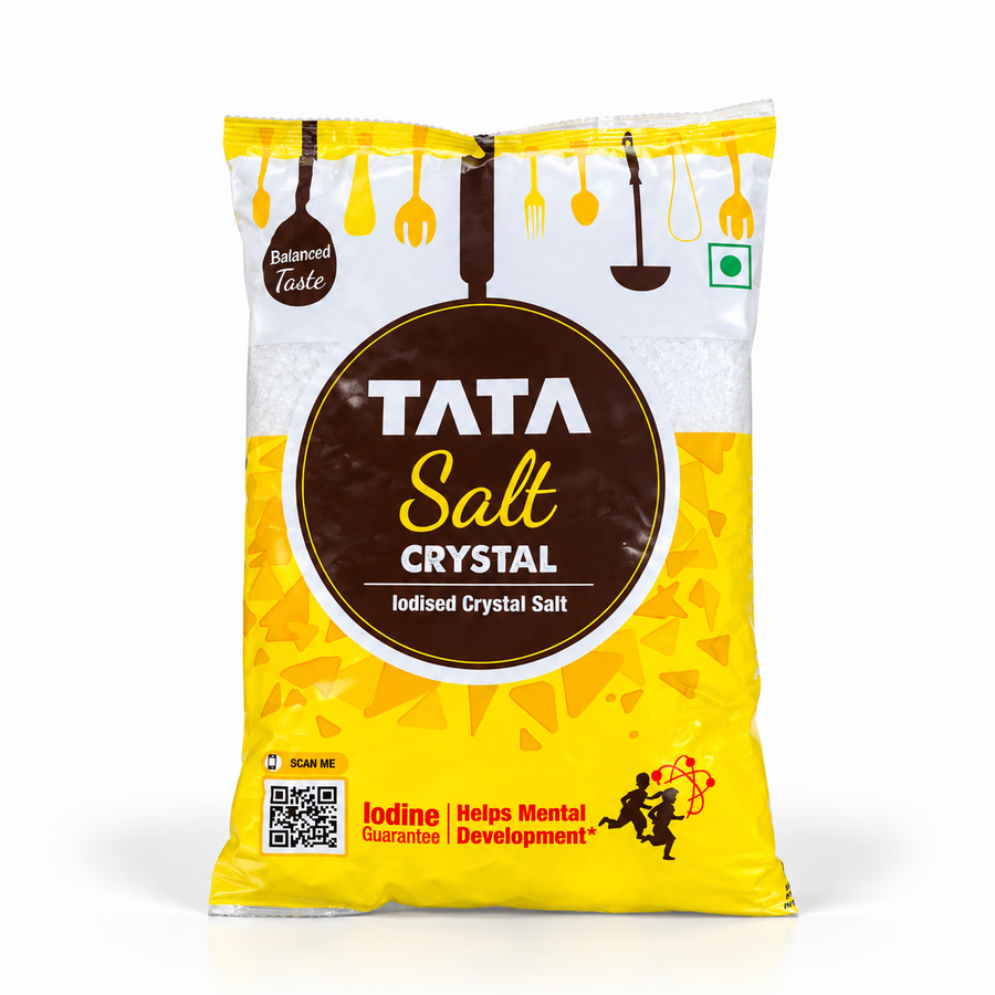 A yellow and white packet of Tata Salt Crystal iodised salt featuring a round brown logo and clear product details. Available in the UK at theindianshelf.co.uk