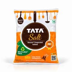 An orange and white pouch of Tata Salt Vacuum Evaporated Iodised Salt featuring a round brown logo and recyclable pack branding. Available in the UK at theindianshelf.co.uk.