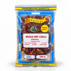 A 100g clear retail pouch of Shankar Whole Dry Chilli Stemless featuring guaranteed quality labeling and visible dried chili pods, centered on a solid white background. Available in the UK at theindianshelf.co.uk.