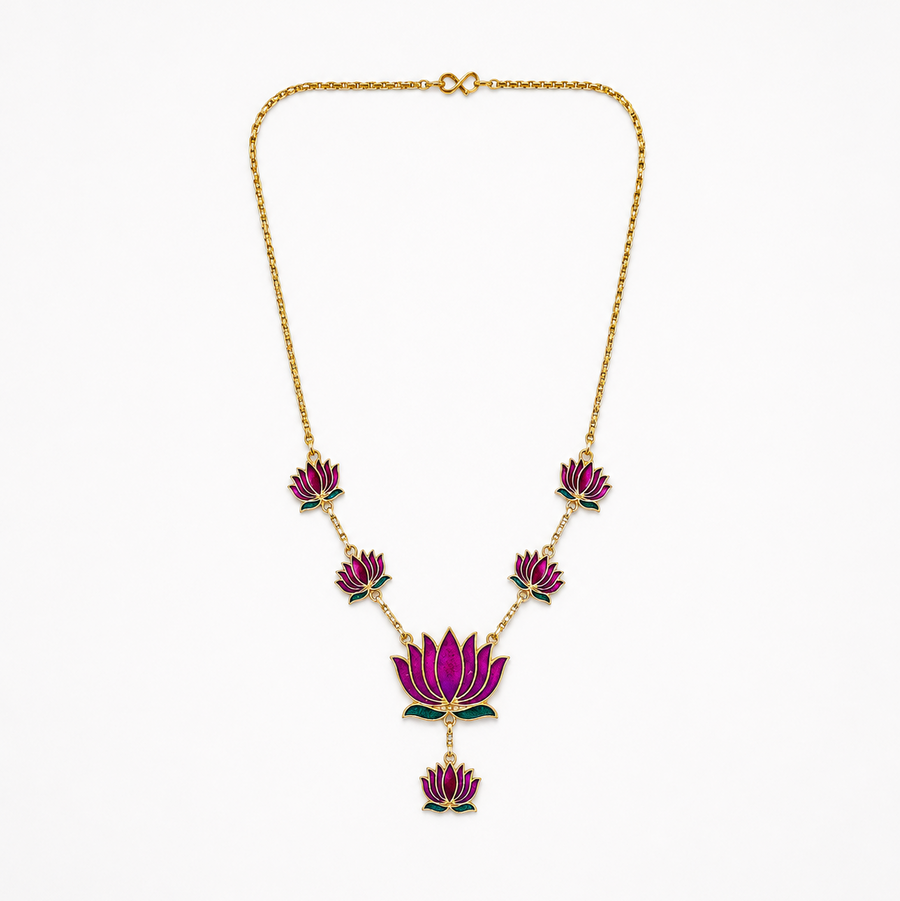 A delicate gold-plated chain necklace featuring multiple violet-purple enamel lotus motifs arranged along the bottom, centered on a solid white background. Available in the UK at theindianshelf.co.uk.