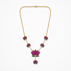 A delicate gold-plated chain necklace featuring multiple violet-purple enamel lotus motifs arranged along the bottom, centered on a solid white background. Available in the UK at theindianshelf.co.uk.
