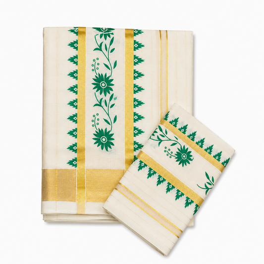 A neatly folded off-white Kerala tissue cotton double set mundu with matching neryathum displayed on a solid white background, featuring a wide gold zari border, green temple edges, and an intricate green floral vine motif. Available in the UK at theindianshelf.co.uk.