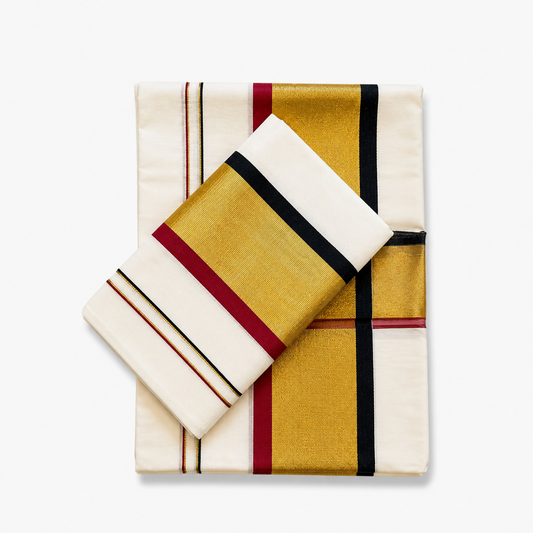 A neatly folded off-white Kerala cotton double set mundu with its matching neryathum folded diagonally on top against a solid white background, displaying wide metallic gold zari bands framed by maroon and black border stripes. Available in the UK at theindianshelf.co.uk.