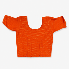 A vibrant orange short-sleeved stretchable readymade saree blouse with a textured jacquard micro-pattern and deep scoop neckline, laid flat against a solid white background. Available in the UK at theindianshelf.co.uk.