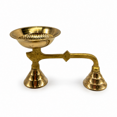 A traditional brass sambrani holder dhoopakal featuring a long handle, dual bases, and a polished fluted bowl, centered on a solid white background. Available in the UK at theindianshelf.co.uk.