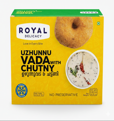 A bright yellow and green box of Royal Delicacy Uzhunnu Vada with Chutny (urad dal vada with chutney). The packaging features a photo of a golden brown, ring-shaped vada at the top right, and a bowl of white coconut chutney garnished with dried red chili peppers and curry leaves at the bottom right. The product is labeled "Fresh Frozen" with "NO PRESERVATIVE." The net weight is 400 gm (0.88 lbs, 14.10 oz).