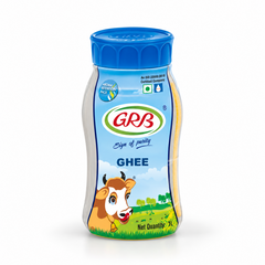 A 1 L white and blue jar of GRB Ghee featuring brand logos, a cow illustration, and an aroma-retention pack design, centered on a solid white background. Available in the UK at theindianshelf.co.uk.