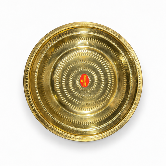 A 13-inch brass thambulam plate featuring a detailed dot-press textured pattern and a polished golden finish, centered on a solid white background. Available in the UK at theindianshelf.co.uk.