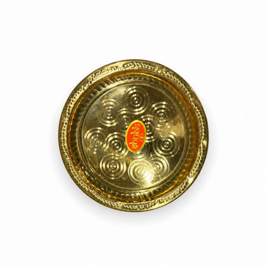 An 8-inch Shubh brass plate featuring concentric circular patterns and a decorative rim, centered on a solid white background. Available in the UK at theindianshelf.co.uk.