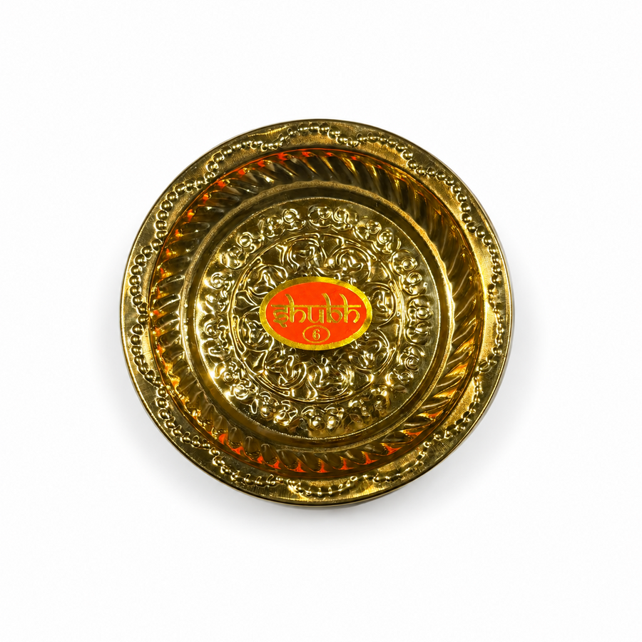 A 6-inch Shubh brass plate featuring intricate embossed patterns and a bright golden polish, centered on a solid white background. Available in the UK at theindianshelf.co.uk.