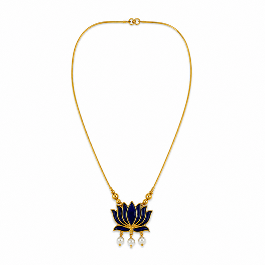A delicate gold-plated chain necklace featuring a dark blue enamel lotus flower pendant with three dangling mini pearls at the bottom, centered on a solid white background. Available in the UK at theindianshelf.co.uk.