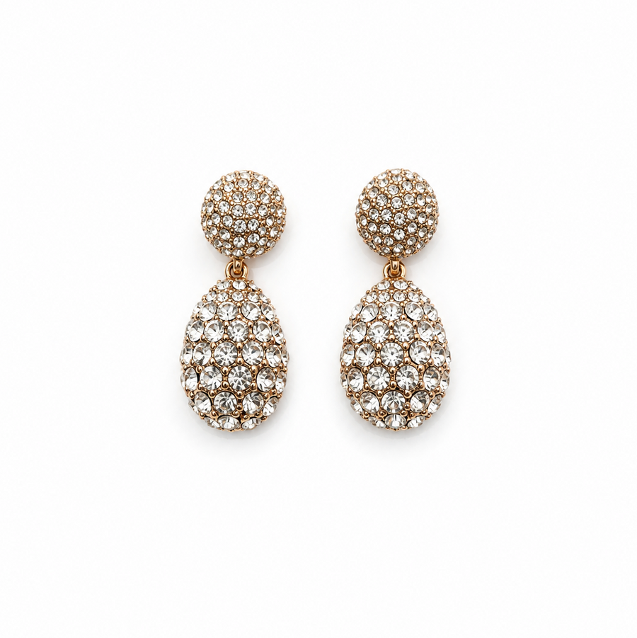 A pair of gold-tone two-tier drop earrings fully encrusted with clear pavé crystals against a solid white background. Available in the UK at indianshelf.co.uk.