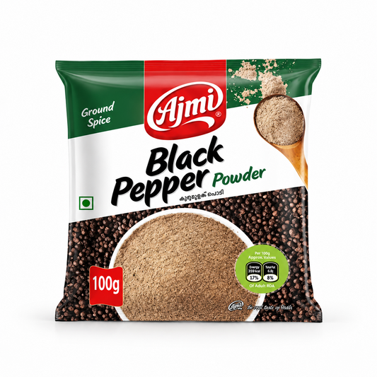 A 100g pack of Ajmi Black Pepper Powder in green and white packaging featuring a bowl of finely ground pepper over whole peppercorns, centered on a solid white background. Available in the UK at theindianshelf.co.uk.