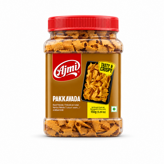 A clear 150g plastic jar with a red lid filled with golden Ajmi Pakkavada ribbon snacks, featuring a brown front label, centered against a solid white background. Available in the UK at indianshelf.co.uk.