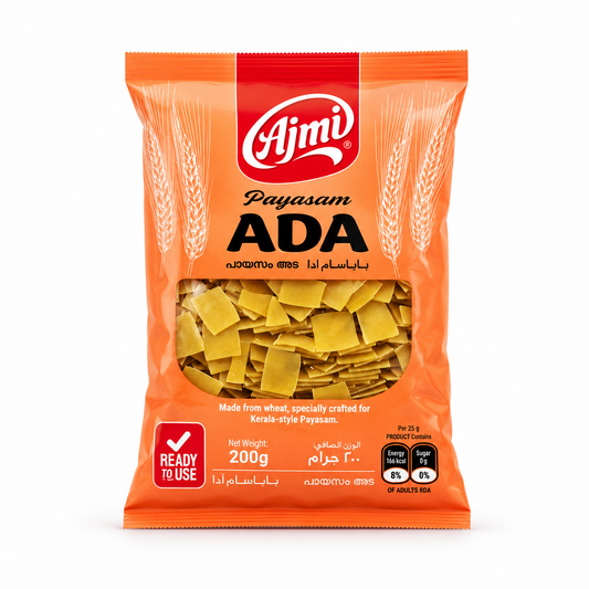 A professional studio product shot of a 200g vertical pillow pouch of Ajmi Payasam Ada standing upright against a solid white background  The packaging is designed with a bright orange theme, featuring a bold red vertical band at the top center containing the white "Ajmi" logo. The product name "Payasam ADA" is printed boldly across the upper half in black. This product is available in the UK at theindianshelf.co.uk.
