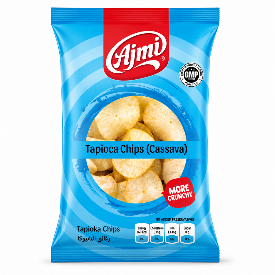 A professional studio shot of the Ajmi Tapioca Chips packaging as seen in image_e01a3d.jpg. The bag features a vibrant sky-blue design with concentric blue circles. The red "Ajmi" logo is centered at the top, and a red "MORE CRUNCHY" seal is featured on the lower right. The bottom of the bag includes a "GMP Certified" badge and a nutritional table showing 160 Kcal energy, 0 mg cholesterol, 1.4 mg iron, and 0 g sugar.This product is available in the UK at theindianshelf.co.uk.