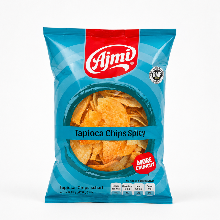 A professional studio shot of a stand-up pillow pouch of Ajmi Tapioca Chips Spicy  The packaging features a vibrant, light cerulean blue background adorned with subtle, deep blue concentric circular patterns. A bold red vertical band drops down from the center top, highlighting the prominent white script "Ajmi" brand logo. To the right of the logo sits a circular silver "GOOD MANUFACTURING PRACTICE - GMP CERTIFIED" stamp. 