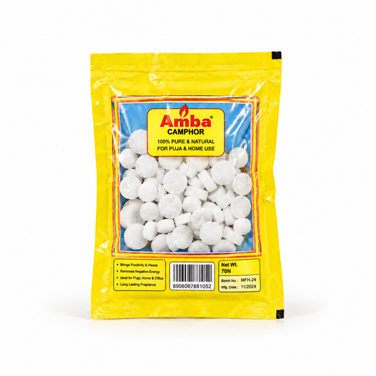 A yellow retail pouch of Amba Camphor Tablets containing 70 white tablets, centered on a solid white background. Available in the UK at theindianshelf.co.uk.