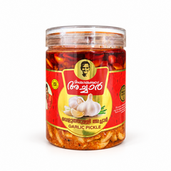 A jar of Ammamayude Achar Garlic Pickle filled with whole garlic cloves in spicy red marinade with Malayalam and English labeling. Available in the UK at theindianshelf.co.uk.
