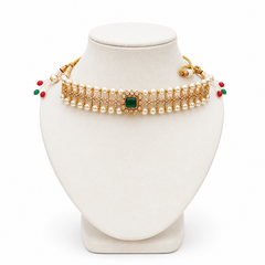 An elegant pearl choker necklace featuring dual pearl borders, sparkling CZ stone filigree, and a central square green emerald stone displayed on a white bust against a solid white background. Available in the UK at indianshelf.co.uk.