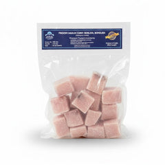 A blue and white vacuum-sealed bag of Aqua Feast Frozen Marlin Cubes. These premium fish cubes are skinless and boneless, offering a convenient, high-protein option for cooking. The clear window on the packaging shows the uniform, pale-colored frozen cubes, while the top label displays the brand name and product details in English and regional Indian languages.This seafood product is available for purchase in the UK at theindianshelf.co.uk.