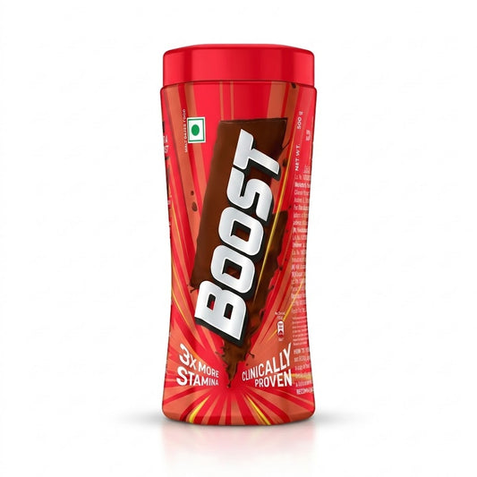A vibrant red jar of Boost, a popular chocolate-flavored malt-based health food drink. The 500g packaging features bold "BOOST" branding on a chocolate splash background. It highlights key benefits such as "3x More Stamina" and that it is "Clinically Proven". The label also includes a green vegetarian symbol and indicates it is a malt-based food.are available for purchase in the UK at theindianshelf.co.uk.